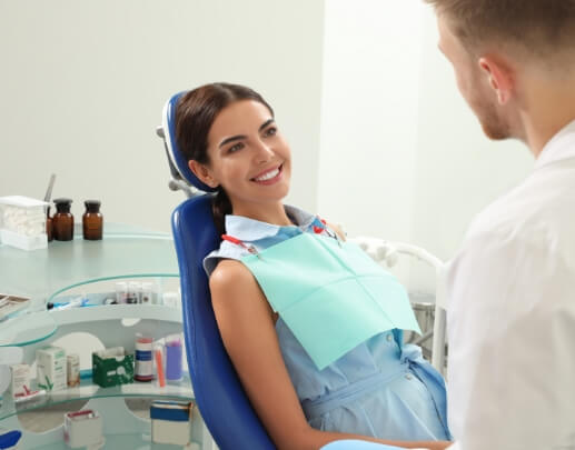 Relaxed dental patient smiling at dentist