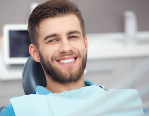 Man smiling after dental checkup and teeth cleaning visit