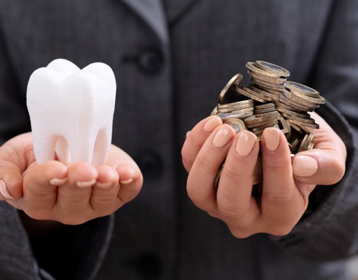 Woman’s hands holding molar and coins