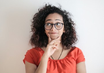 Thinking woman with her hand on her chin