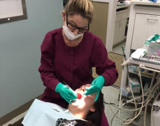 Woman thinking about cost of dental emergencies in Annapolis