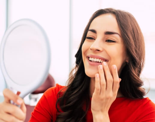 Smiling woman enjoying the benefits of dental implants