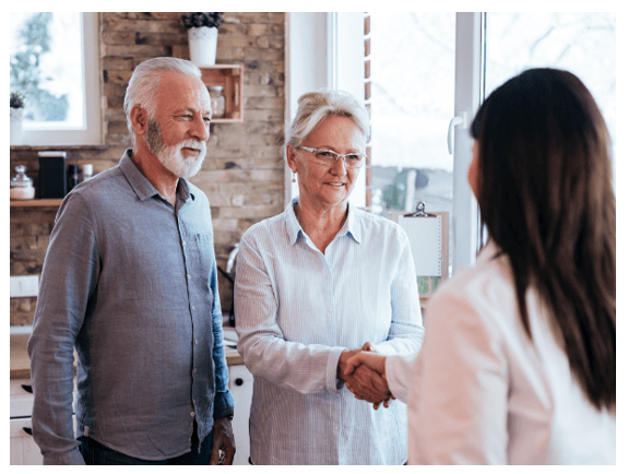 Three friendly dental team members in front of dental office