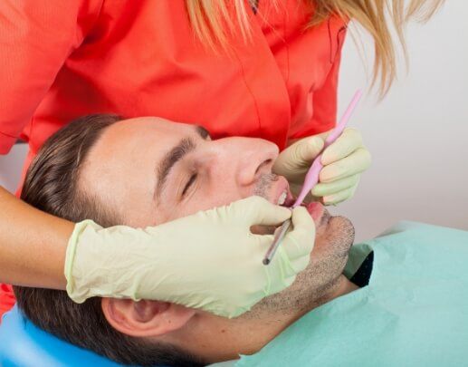 Dental patient receiving periodontal therapy