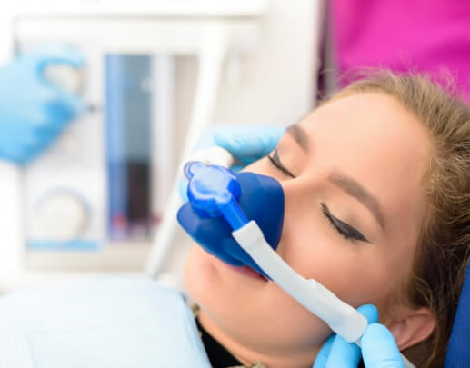 Dental patient receiving nitrous oxide sedation dentistry treatment