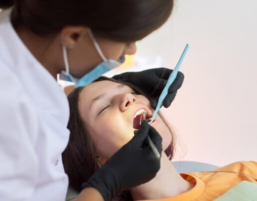 Dental patient under oral conscious dental sedation receiving treatment