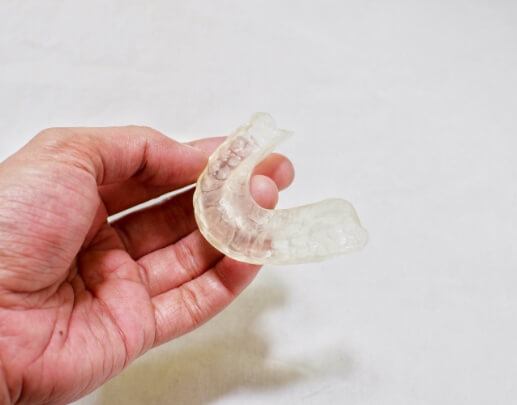 Hand holding an occlusal splint