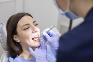woman smiling receiving oral exam